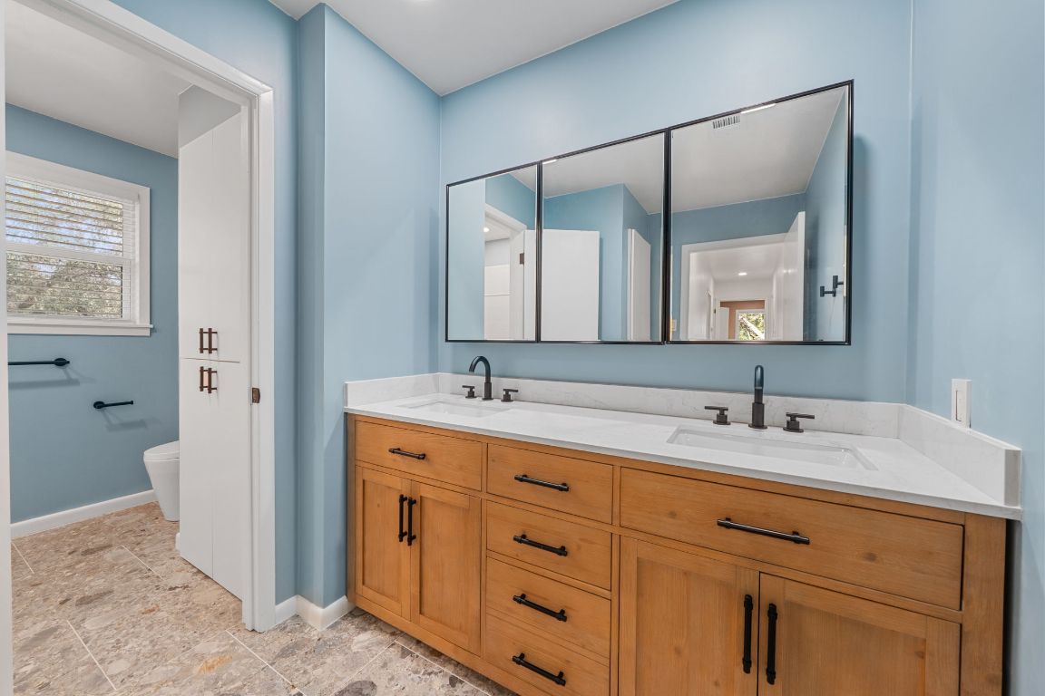 2175 Park Road New Braunfels, TX 78132 - Photo 26 of 39 Bathroom with double vanity and baseboards
