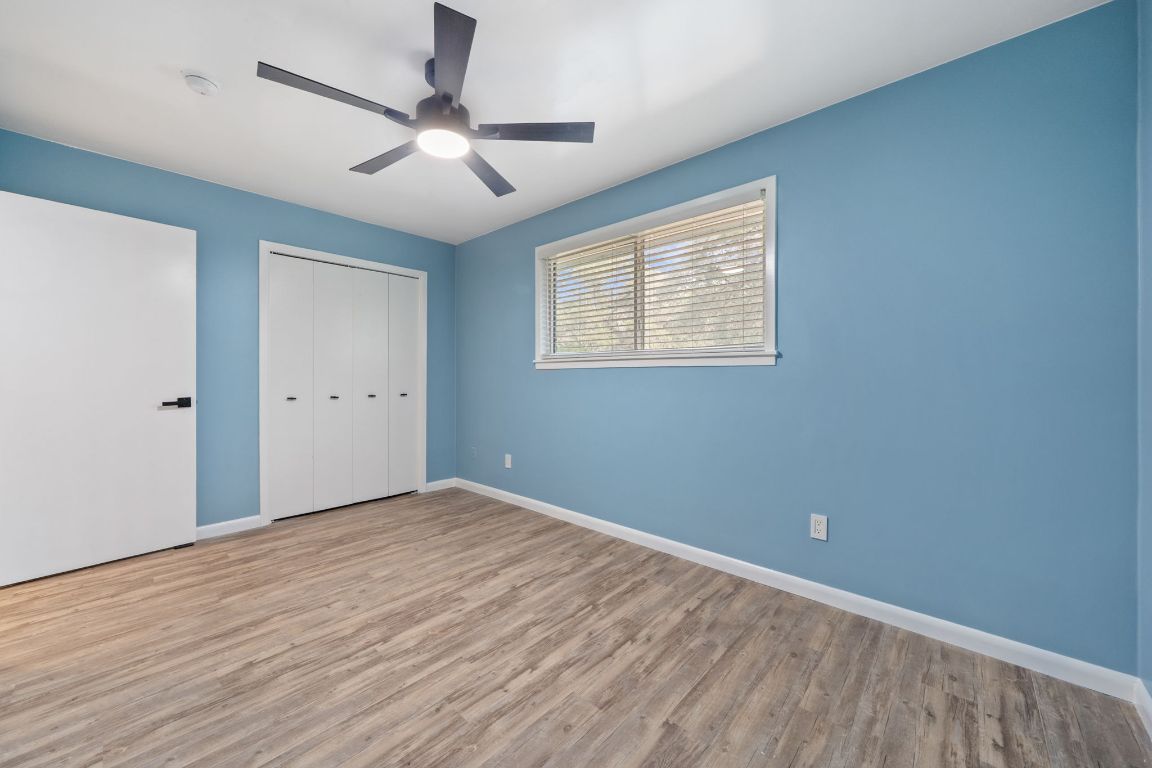 2175 Park Road New Braunfels, TX 78132 - Photo 27 of 39 Unfurnished bedroom featuring wood finished floors, a closet, and a ceiling fan