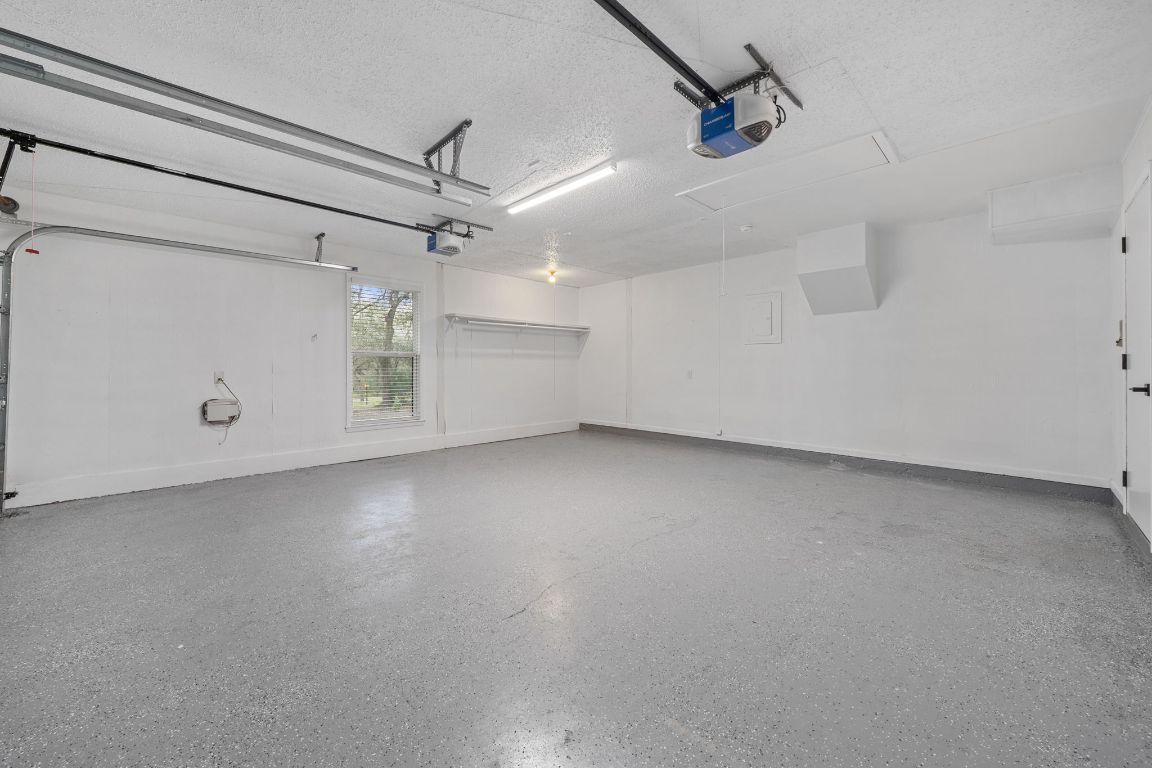 2175 Park Road New Braunfels, TX 78132 - Photo 33 of 39 Garage with a garage door opener and baseboards