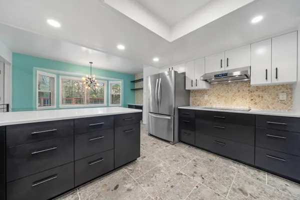 a living room with stainless steel appliances kitchen island furniture and a kitchen view
