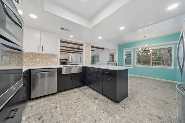 a kitchen with cabinets and stainless steel appliances