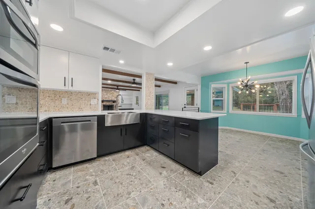 a kitchen with cabinets and stainless steel appliances