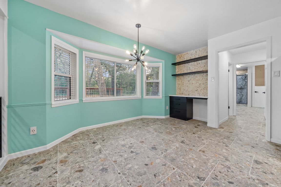 2175 Park Road New Braunfels, TX 78132 - Photo 9 of 39 Unfurnished dining area with baseboards and a chandelier