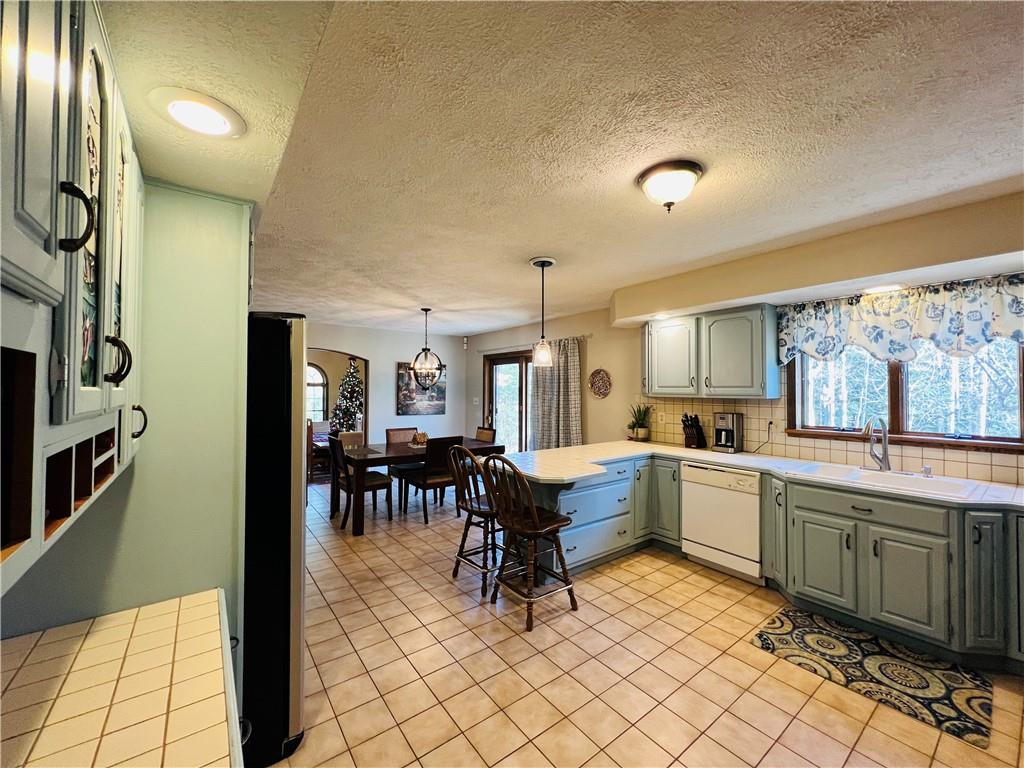 789 Cleland Mill Road New Castle, PA 16102 - Photo 14 of 25 a kitchen with a sink and chairs