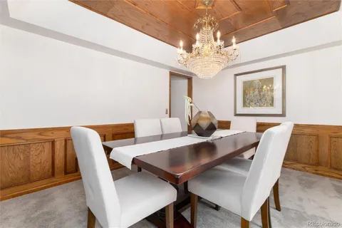 a view of a dining room with furniture and chandelier
