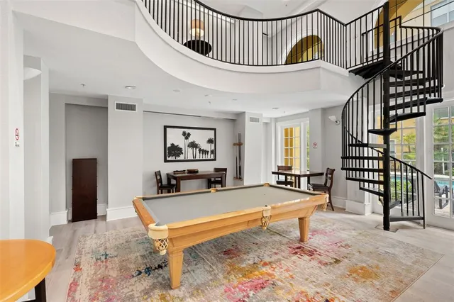 a living room with a bed and a table