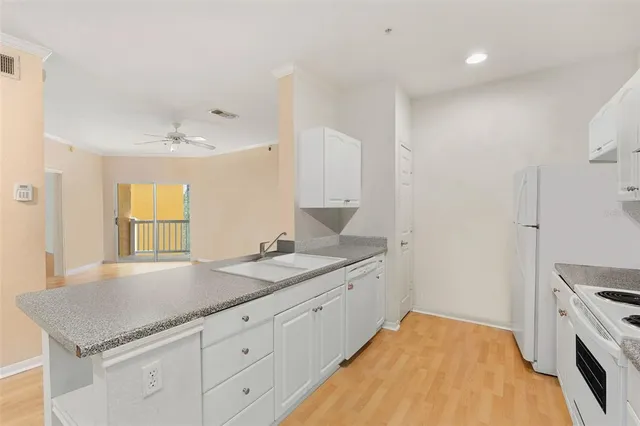 a spacious bathroom with a granite countertop sink and a mirror