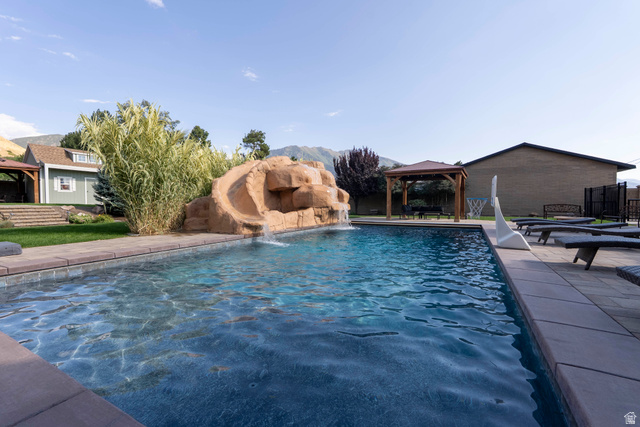 687 South 2080th Street East Springville, UT 84663 - Photo 100 of 149 In-ground swimming pool featuring a rock-style waterfall and slide