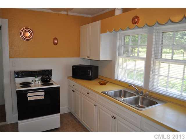 3320 Beaty Road Gastonia, NC 28056 - Photo 6 of 16 a kitchen with a sink a stove and cabinets