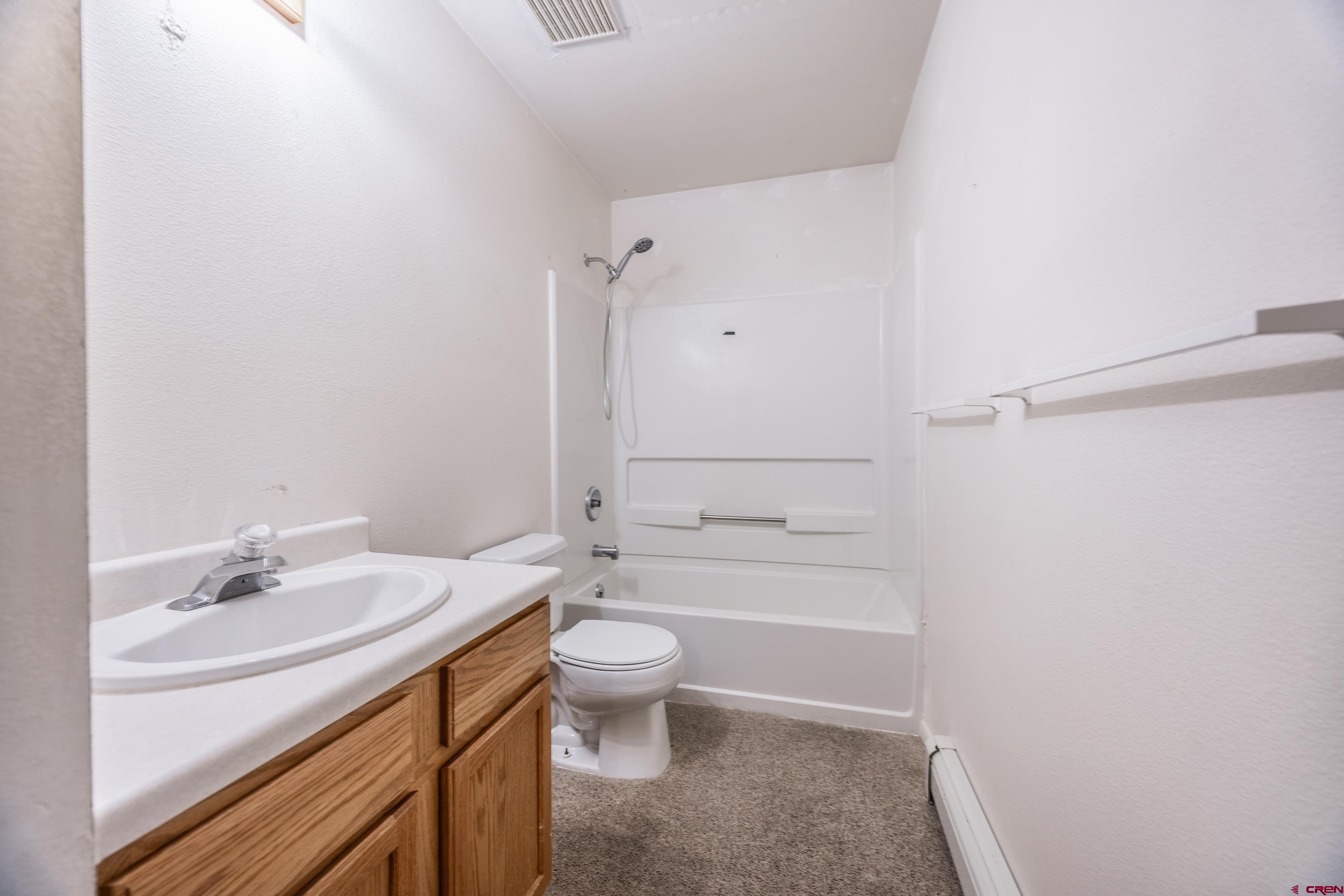 17377 Breeze Road Delta, CO 81416 - Photo 12 of 45 a bathroom with a sink a toilet and shower