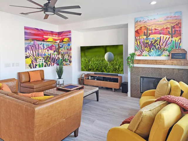 a bedroom with a bed and painting on the wall