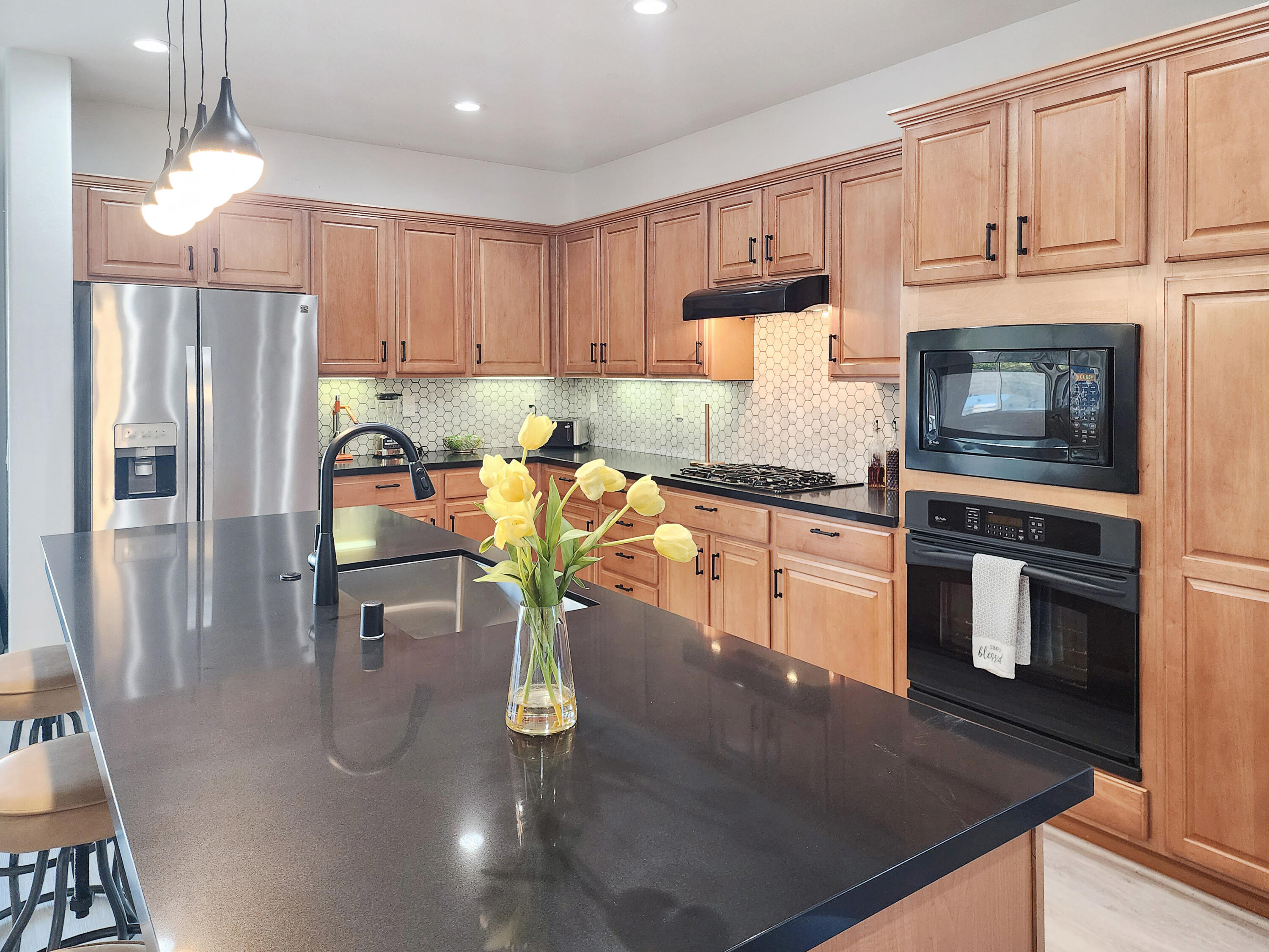 84450 Onda Drive Indio, CA 92203 - Photo 7 of 52 a kitchen with stainless steel appliances granite countertop a sink refrigerator and cabinets