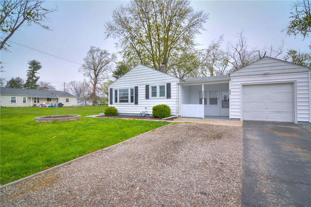 3506 East Leafdale Avenue Decatur, IL 62521 - Photo 5 of 25 a front view of a house with a garden and trees