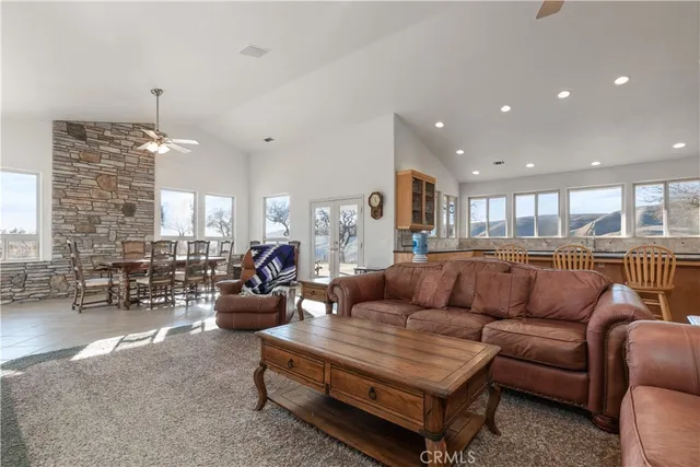 a kitchen with granite countertop white cabinets and a large window