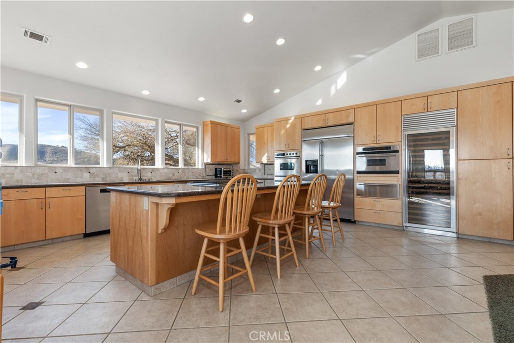 75751 Indian Valley Road San Miguel, CA 93451 - Photo 38 of 60 a kitchen with granite countertop cabinets a table and chairs in it