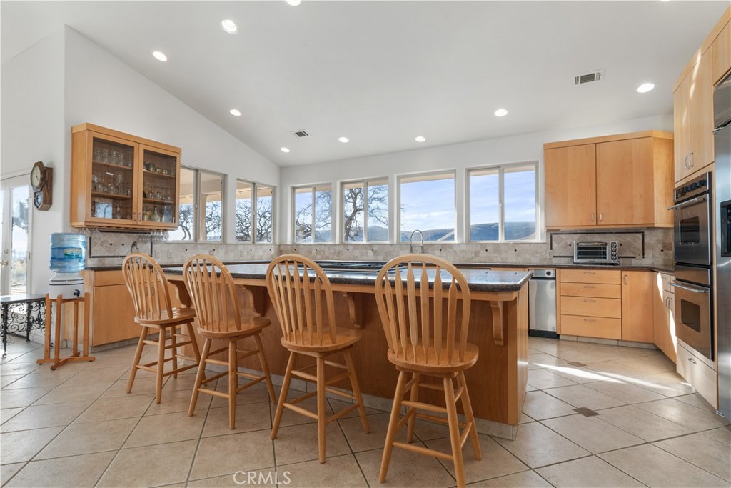 75751 Indian Valley Road San Miguel, CA 93451 - Photo 39 of 60 a kitchen with stainless steel appliances granite countertop a stove a sink a table and chairs
