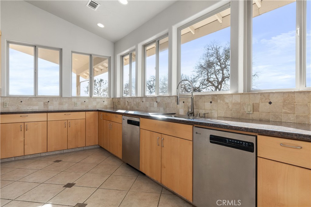 75751 Indian Valley Road San Miguel, CA 93451 - Photo 40 of 60 a kitchen with granite countertop white cabinets and a large window