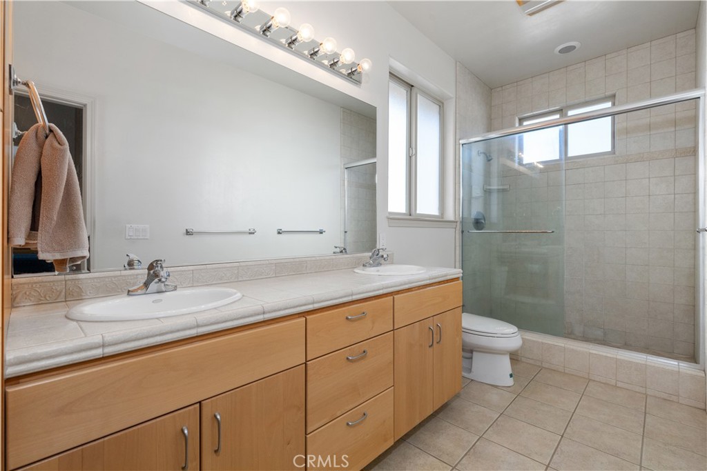 75751 Indian Valley Road San Miguel, CA 93451 - Photo 51 of 60 a bathroom with a granite countertop sink a toilet and a mirror