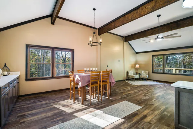 a view of a livingroom with a ceiling fan and window