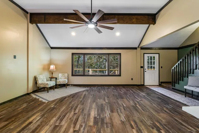 a view of a livingroom with furniture and a ceiling fan