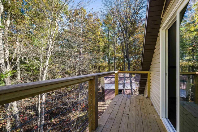 a view of a balcony with wooden floor and fence