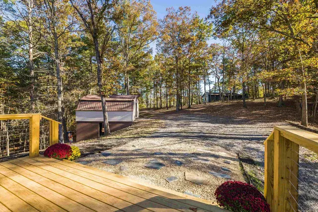 a room with stainless steel appliances kitchen island granite countertop a sink and cabinets