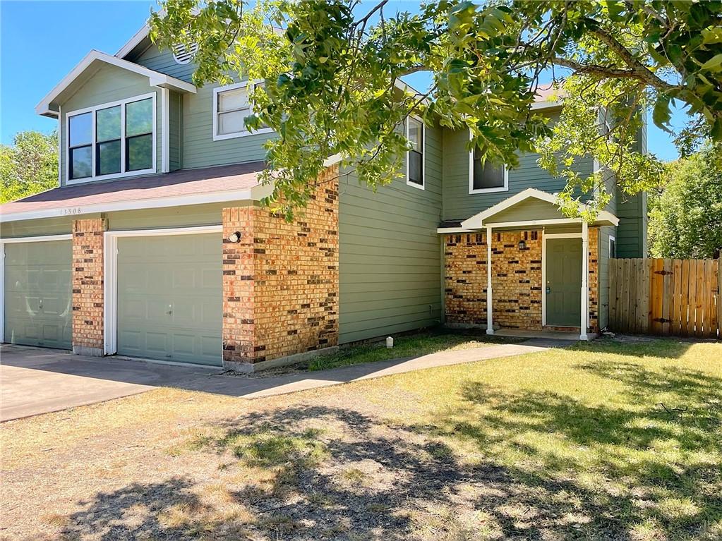 13308 Saddlebrook Trail, Unit A Austin, TX 78729 - Photo 1 of 1 a front view of a house with a yard and garage