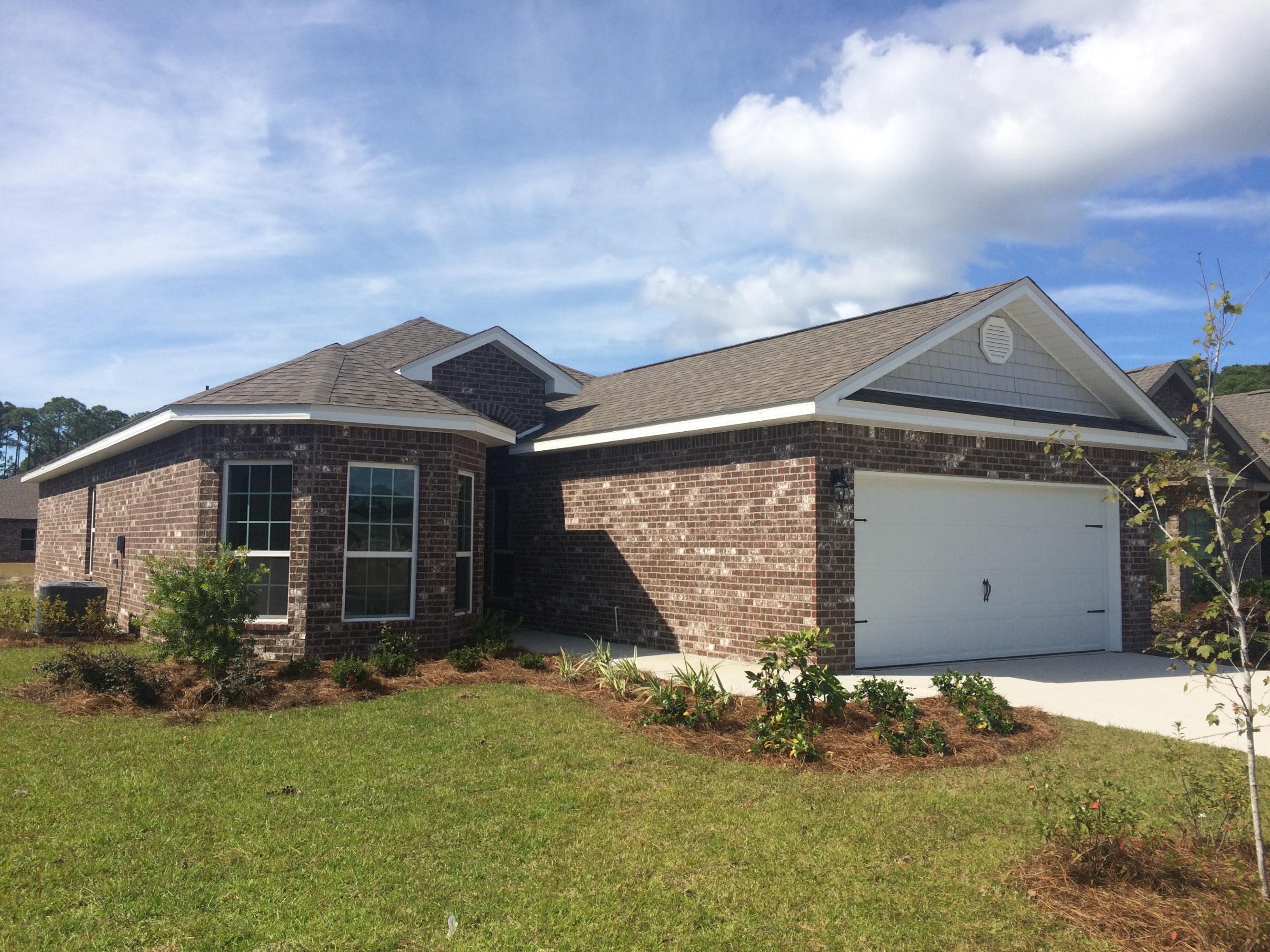 439 Pin Oak Loop Santa Rosa Beach, FL 32459 - Photo 1 of 17 a front view of a house with garden