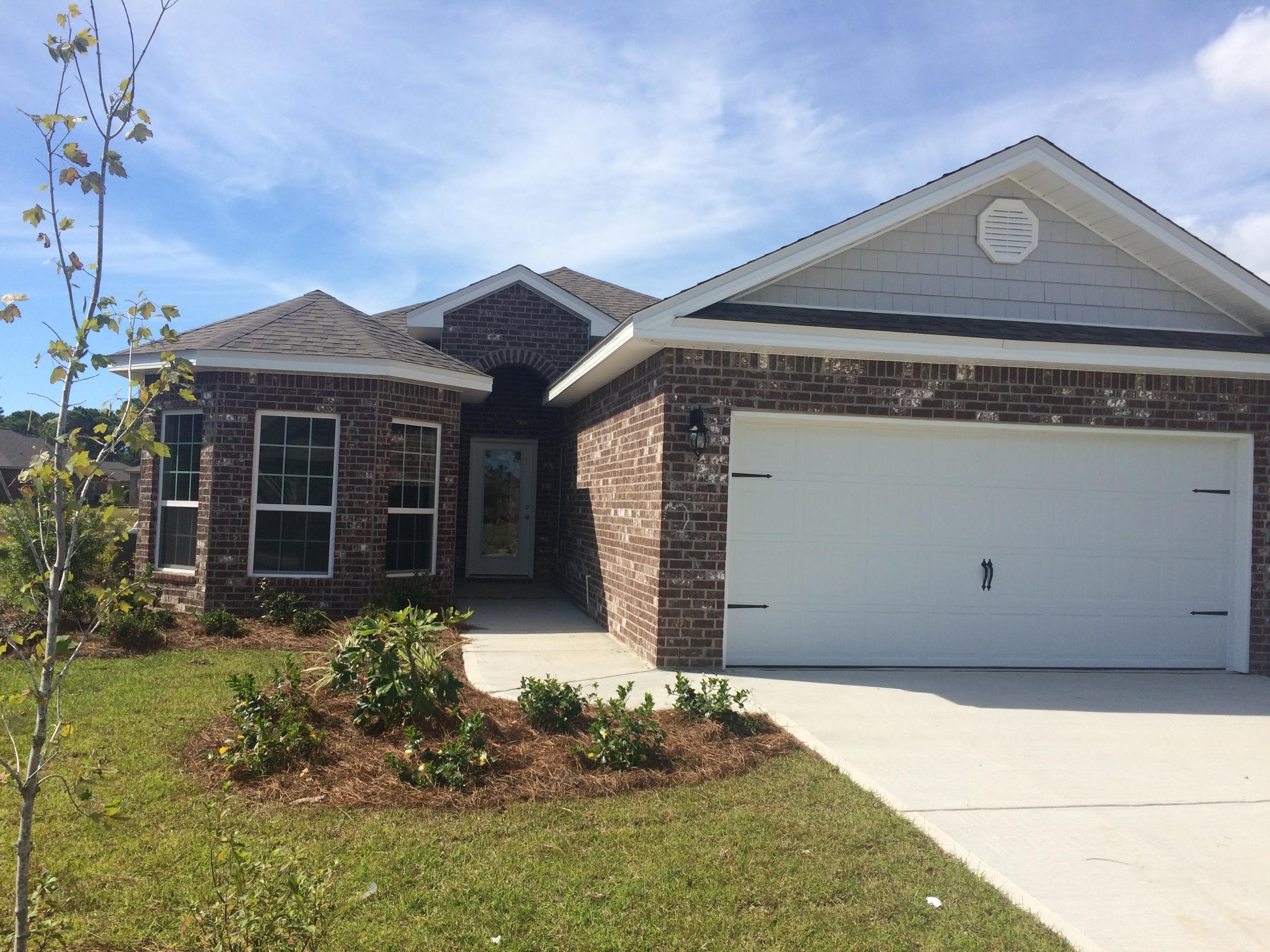 439 Pin Oak Loop Santa Rosa Beach, FL 32459 - Photo 3 of 17 a front view of a house with garden