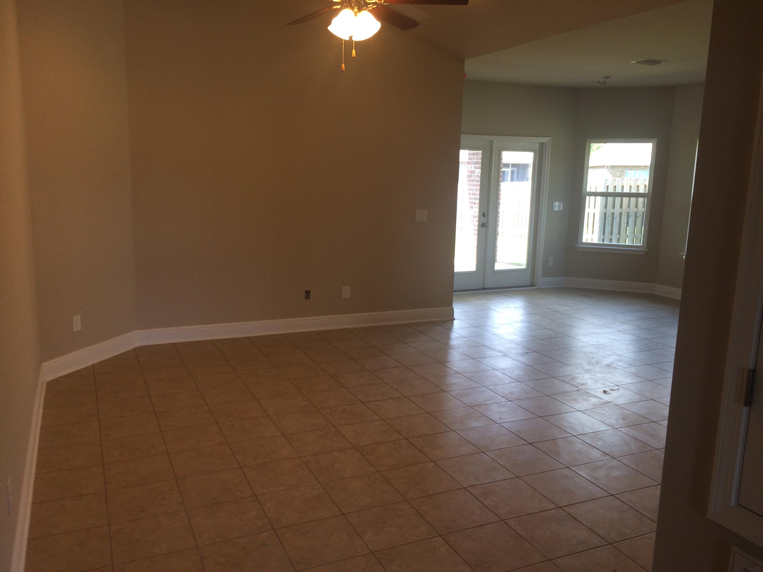 439 Pin Oak Loop Santa Rosa Beach, FL 32459 - Photo 5 of 17 wooden floor in an empty room with a window