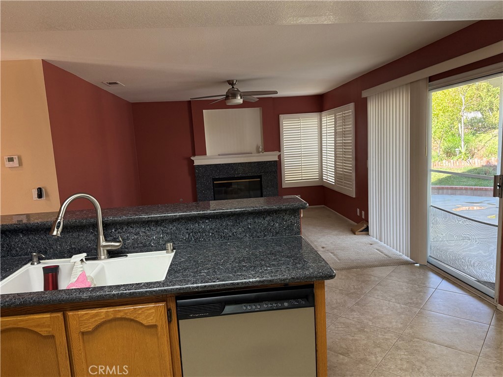 2000 Citrus Wood Lane Riverside, CA 92503 - Photo 13 of 51 a kitchen with a sink a counter top space and stainless steel appliances wooden floor
