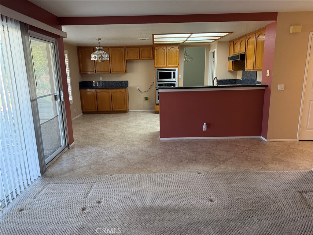 2000 Citrus Wood Lane Riverside, CA 92503 - Photo 16 of 51 an empty room with window and stainless steel appliances