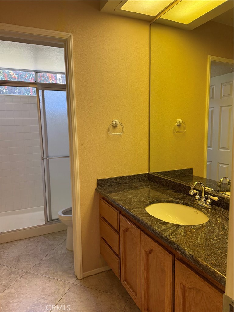2000 Citrus Wood Lane Riverside, CA 92503 - Photo 19 of 51 a bathroom with a granite countertop sink and a mirror