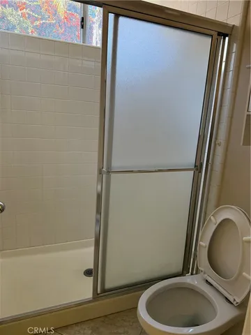 a bathroom with a granite countertop toilet and a sink