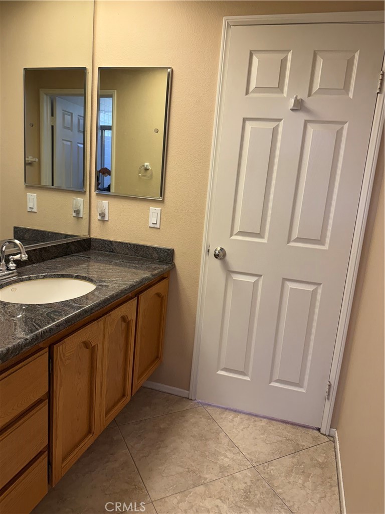 2000 Citrus Wood Lane Riverside, CA 92503 - Photo 21 of 51 a bathroom with a granite countertop sink and a mirror