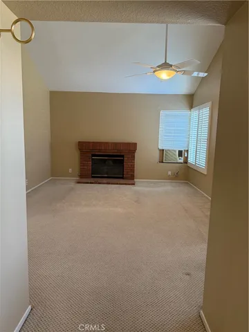 a view of an empty room with a fireplace
