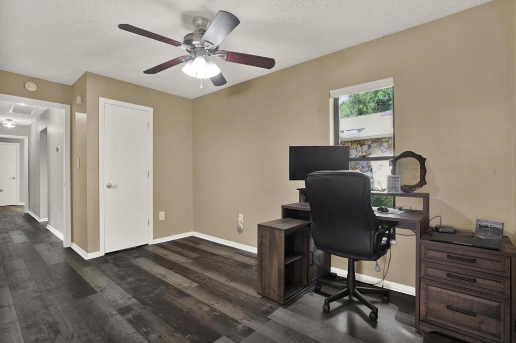 7487 River Country Drive Weeki Wachee, FL 34607 - Photo 37 of 53 a workspace with chandelier