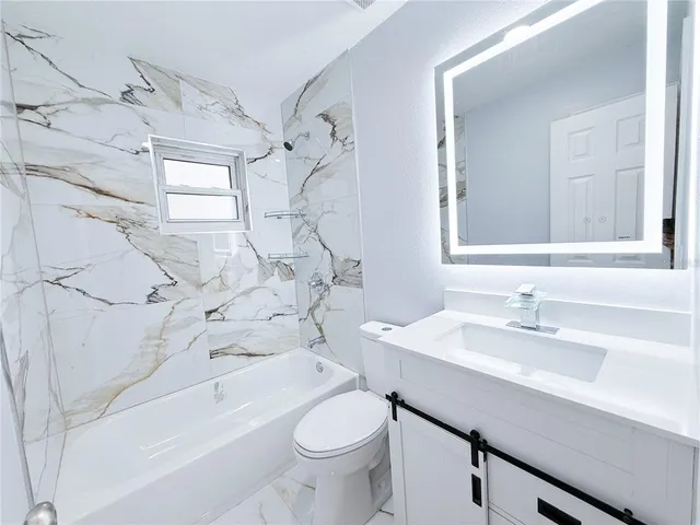 a view of kitchen and hall with wooden floor