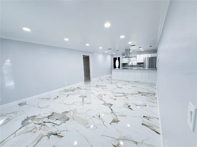 a view of a bedroom with a large bed and a window