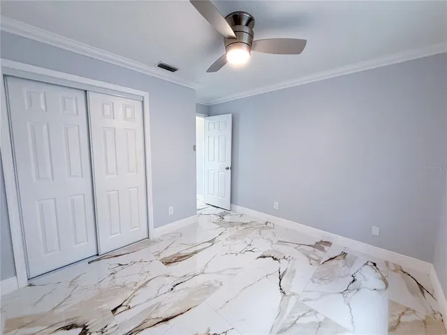 a view of a bedroom with a bed and a window
