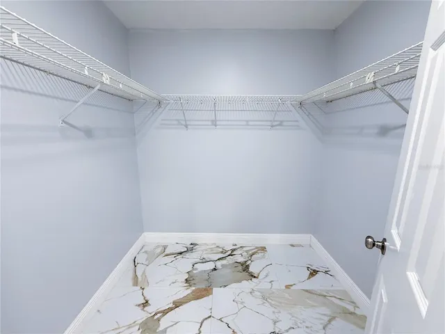 a white toilet sitting next to a bath tub and a shower