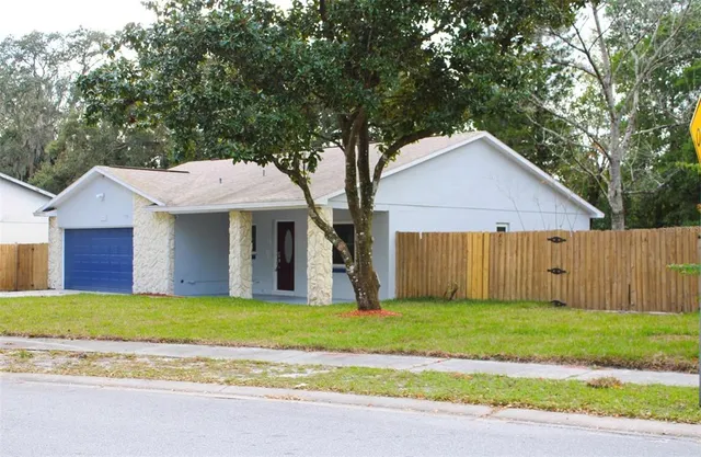 a view of a house with a yard and sitting area