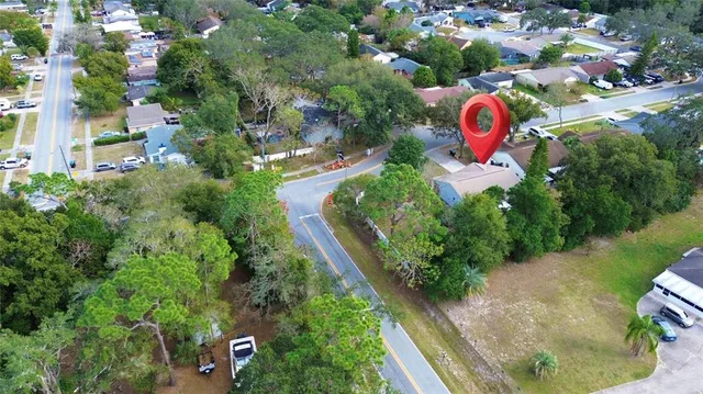 an aerial view of residential houses with outdoor space and street view