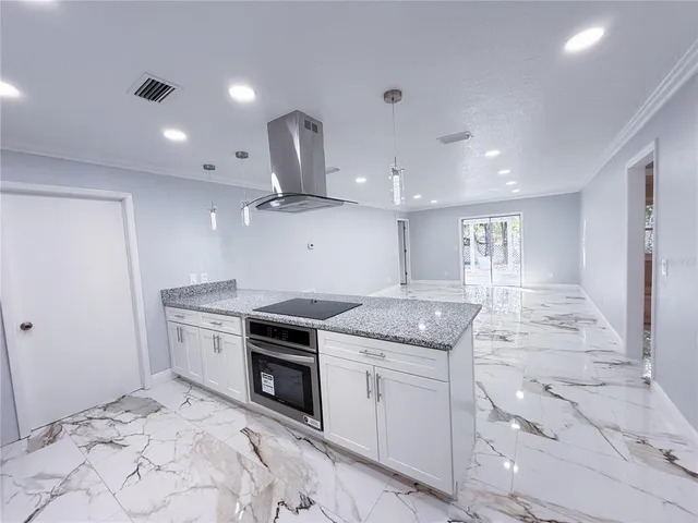 a kitchen with a sink and chandelier