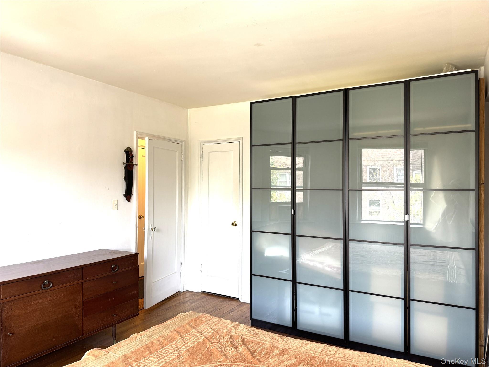 141-24 78th Road, Unit 3A Queens, NY 11367 - Photo 6 of 18 a bedroom with a bed and a window