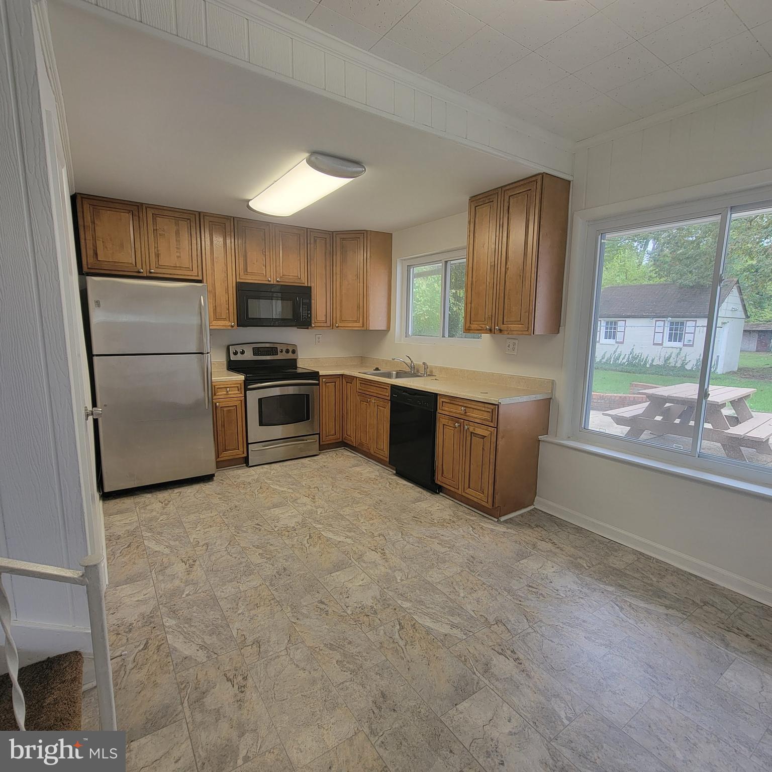 13300 Williams Drive Brandywine, MD 20613 - Photo 6 of 17 a large kitchen with cabinets and stainless steel appliances