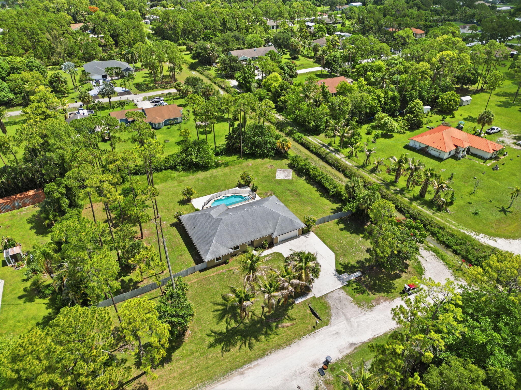 15731 85th Road North Loxahatchee, FL 33470 - Photo 52 of 65 an aerial view of a house with a garden