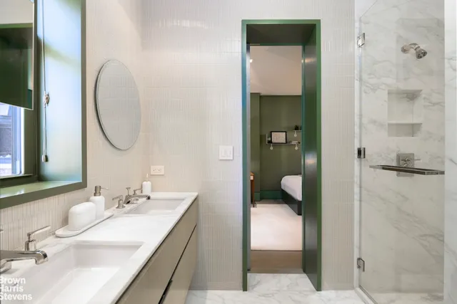 a en suite bathroom with a granite countertop sink and a mirror