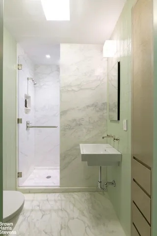 a bathroom with a shower and a sink