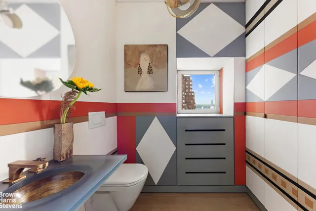 a bathroom with a sink mirror vanity and toilet